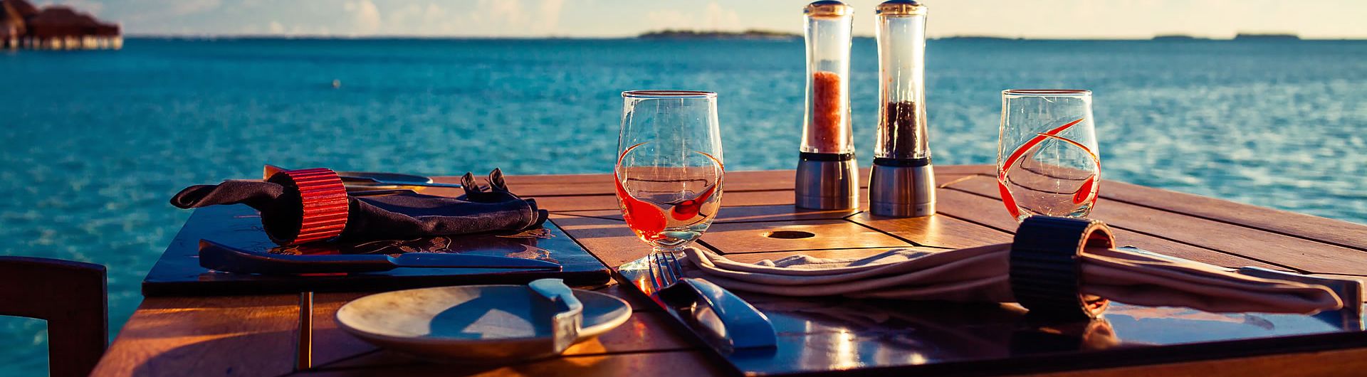 Table setting overlooking lake at sunset